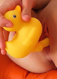 Blond and blue-eyed teen Pinky June masturbating with duck